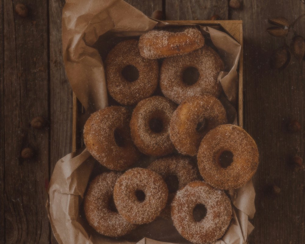 Cider donuts rolled in cinnamon sugar on a tray